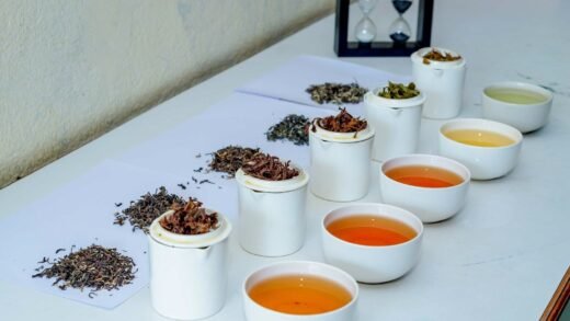 a table topped with cups filled with different types of tea